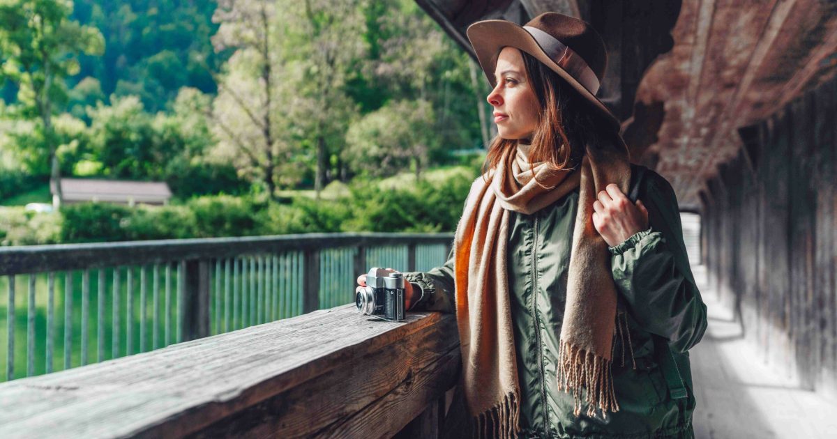 Attractive tourist with a retro camera outdoors